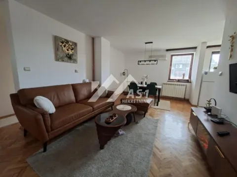 Dnevna soba sa kožnom garniturom i trpezarijskim delom u pozadini. - image 3