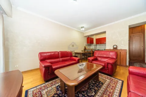 Living room with red leather sofas and a dining area in the background. - image 3