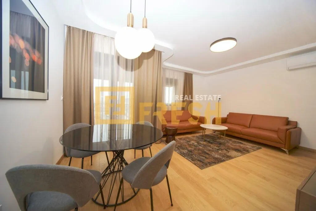 Living room with dining area, sofa set, and table with chairs.