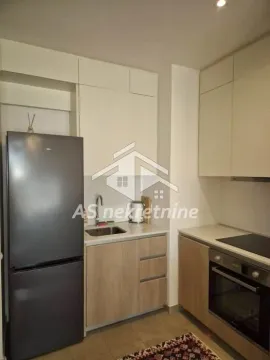 Compact modern kitchen with fitted appliances and a refrigerator. - image 7
