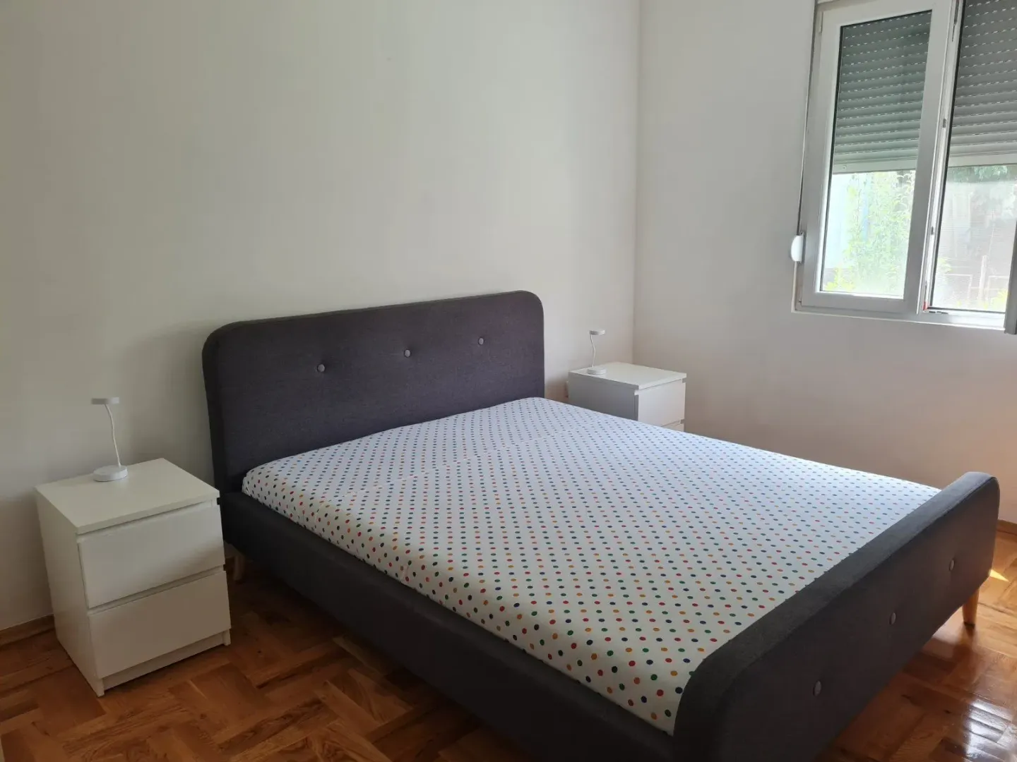Bright bedroom with a double bed and two nightstands.