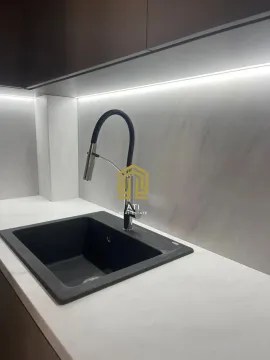 Close-up of the sink and countertop in a modern kitchen. - image 5