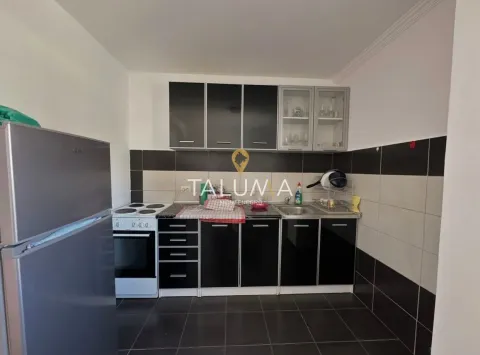 Small kitchen with black cabinets and a white stove. - image 4