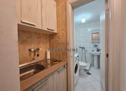 View from the kitchen towards the bathroom with a washing machine. - image 5