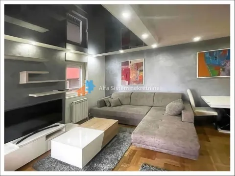 Living room with sofa, coffee table and television. - image 3