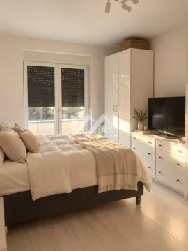 Furnished bedroom with a double bed, wardrobe, and TV chest of drawers. - image 4