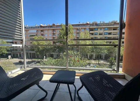 Furnished balcony with seating set and city view. - image 8