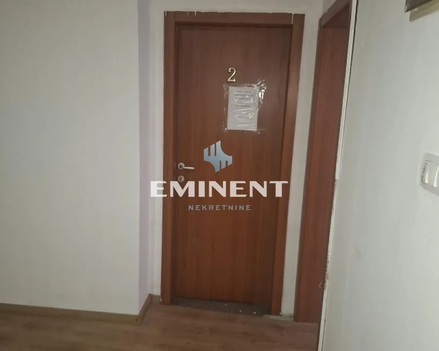 A hallway with wooden interior doors.