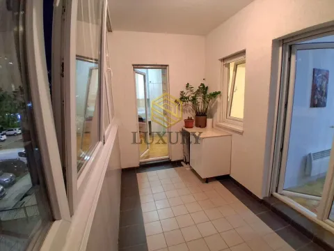 Enclosed balcony with tiled flooring and windows. - image 8
