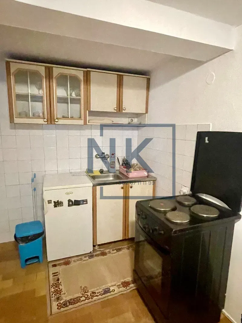 Small kitchen with cabinets, refrigerator, and stove.