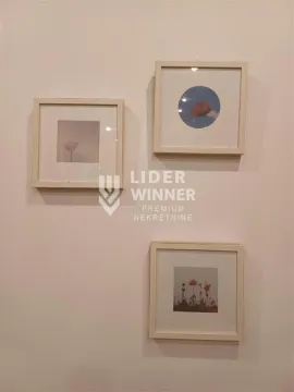 Detail with framed pictures on the wall. - image 9
