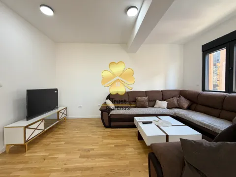 Spacious living room with a sectional sofa, TV unit, and hardwood flooring. - image 2
