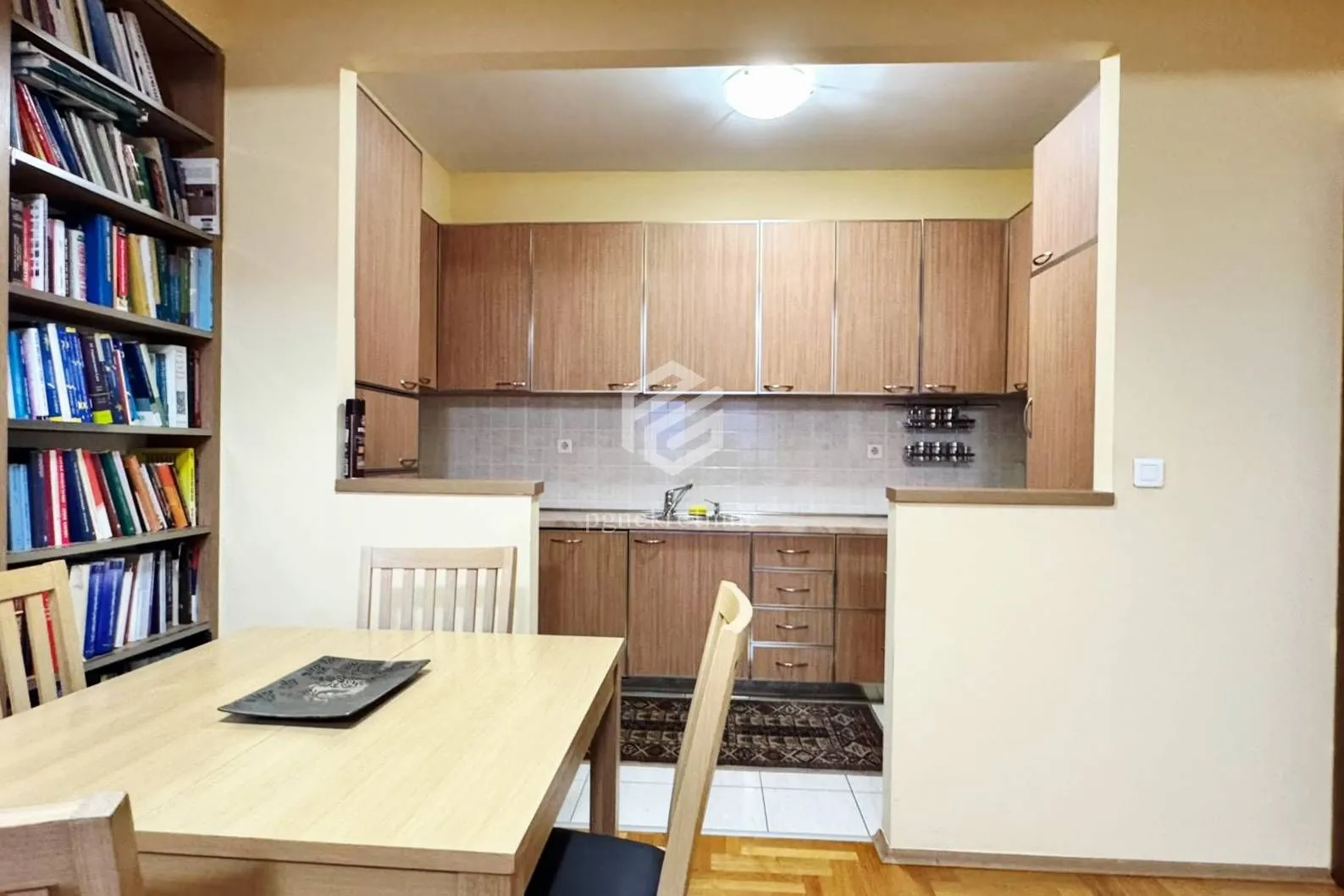 Dining area with a dining table and a view of the fitted kitchen.