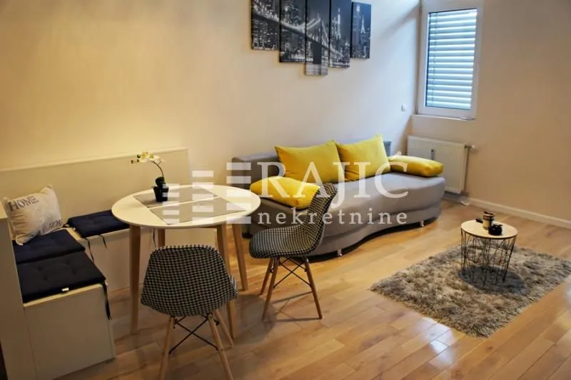 Living room with a sofa and dining table.