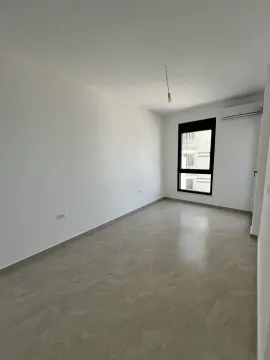 An empty, bright room with tiled floors and air conditioning. - image 6