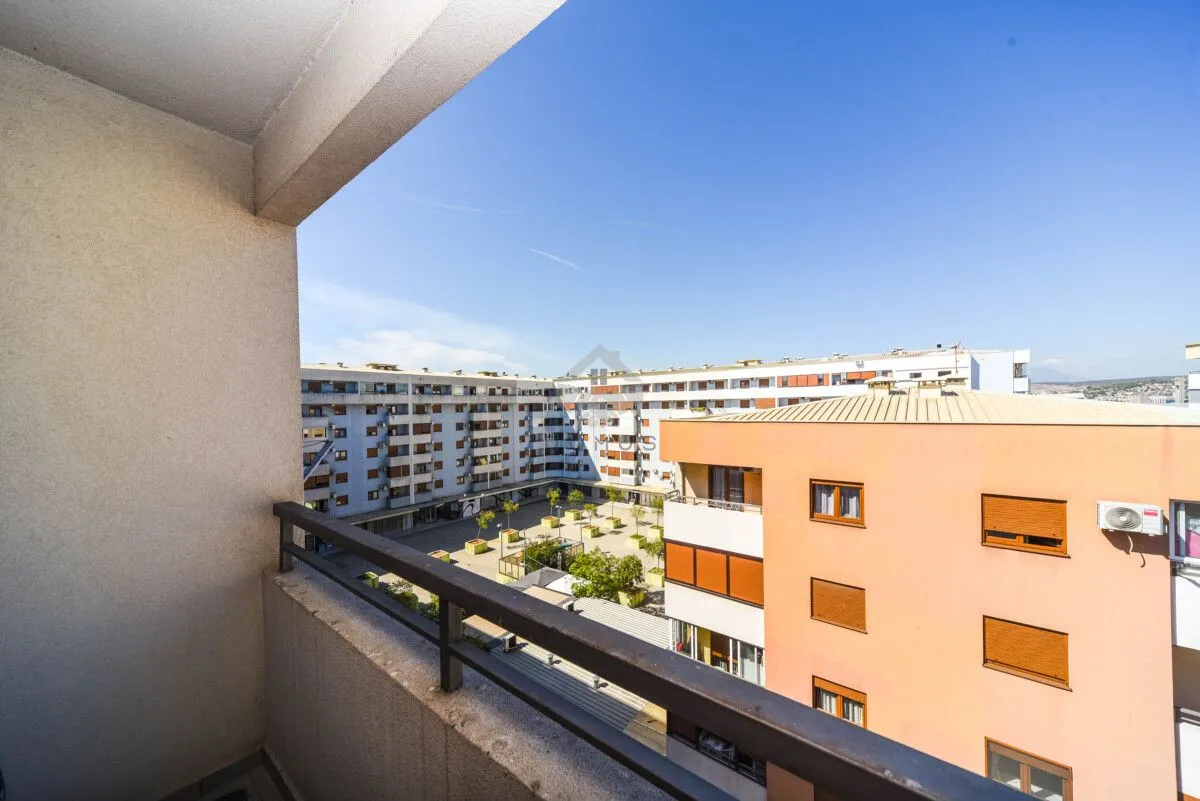 View from the balcony overlooking surrounding residential buildings and courtyard.