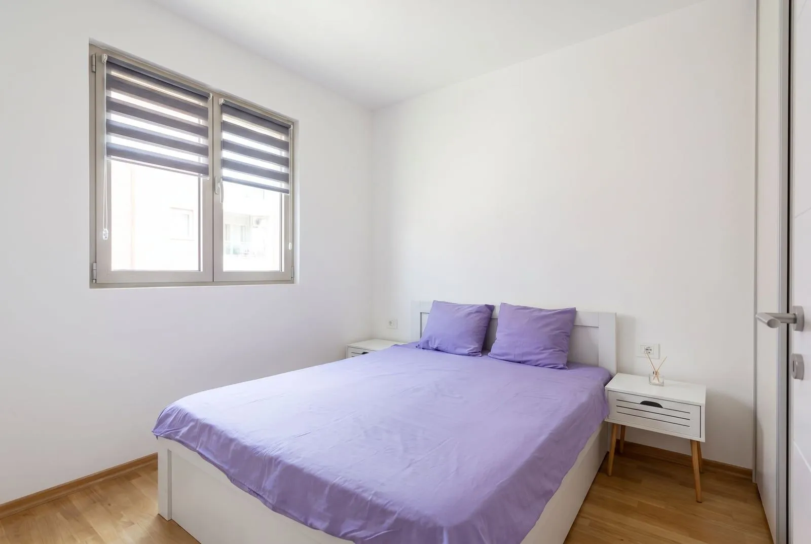 Bright bedroom with a double bed and a window.