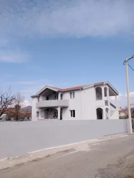 A two-story house with a gray facade and a fenced yard. - image 17