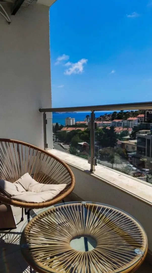 Furnished balcony with seating and sea view.