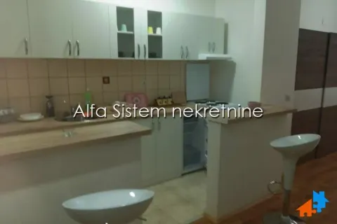Small kitchen with cabinets and a breakfast bar in the apartment. - image 7