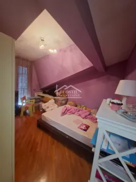 Attic bedroom with a bed and purple walls. - image 12