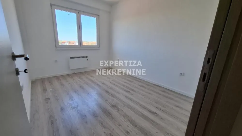 Empty room with laminate flooring and a window.