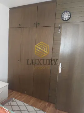 Bedroom with a built-in wardrobe and wooden wall paneling. - image 8