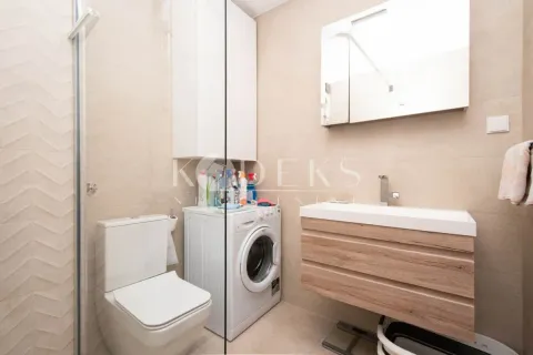 Modernly equipped bathroom with a shower cabin, washbasin, and washing machine. - image 7