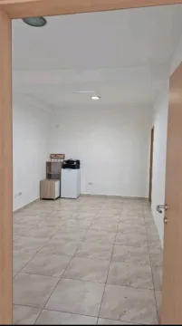 Empty room with ceramic floor tiles, viewed through a doorway. - image 3