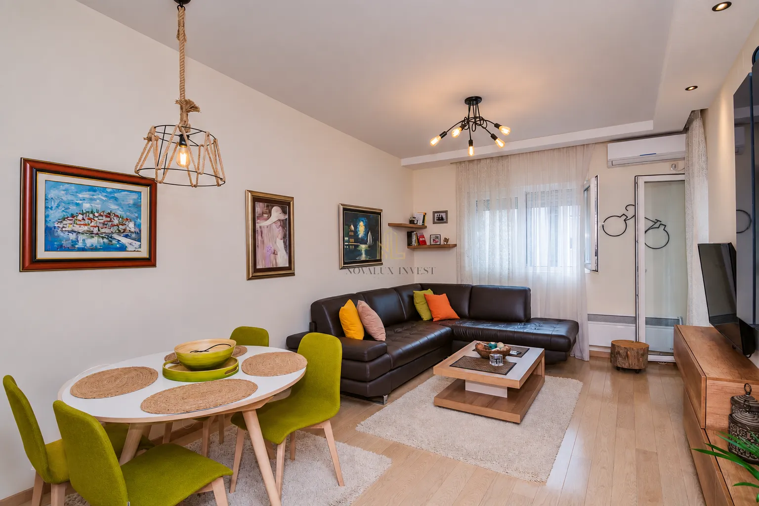 Living room with sofa set, dining table and TV.