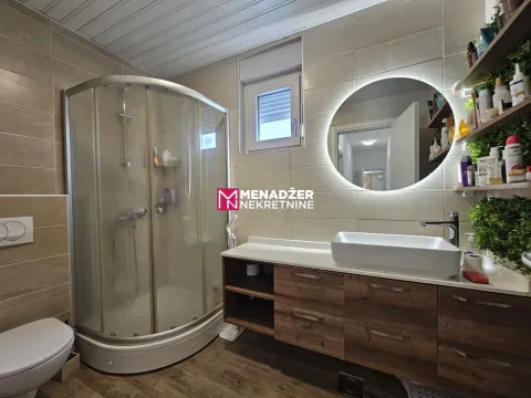 Modernly equipped bathroom with a shower cabin, washbasin, and backlit mirror. - image 8