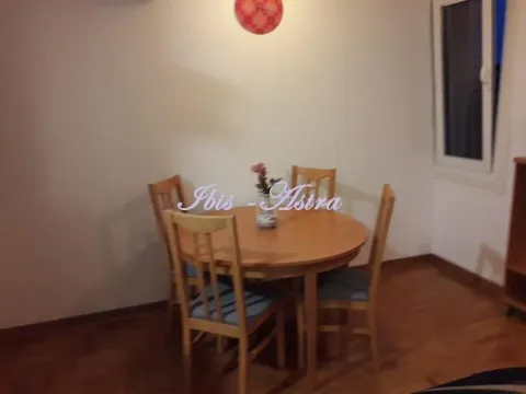 Dining table with four chairs in a bright room. - image 4
