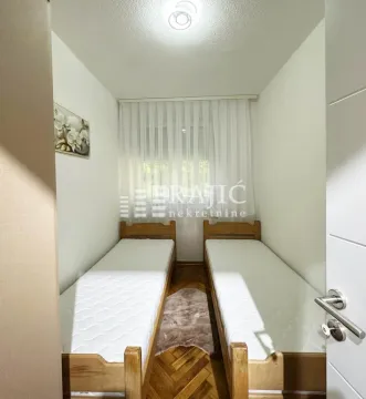 Small bedroom with two wooden beds. - image 4
