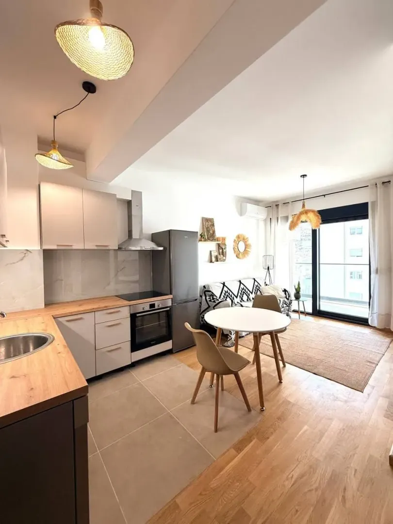 Modern bright living room connected with the kitchen and dining area.