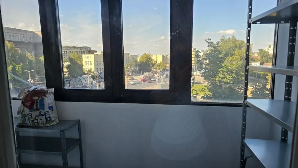 View through the window of a city street and surrounding buildings.