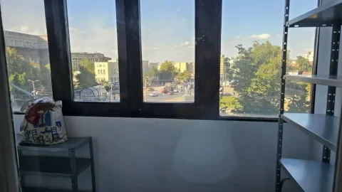 View through the window of a city street and surrounding buildings. - image 6