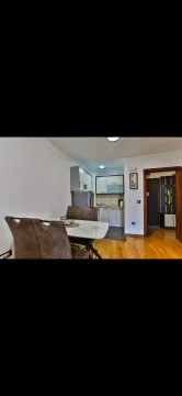 Dining area with a table and chairs overlooking the kitchen. - image 9