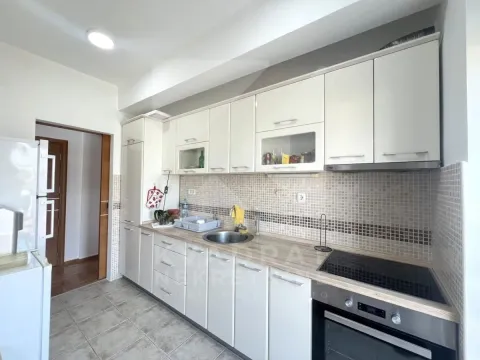 Kitchen with white cabinetry and built-in appliances. - image 4