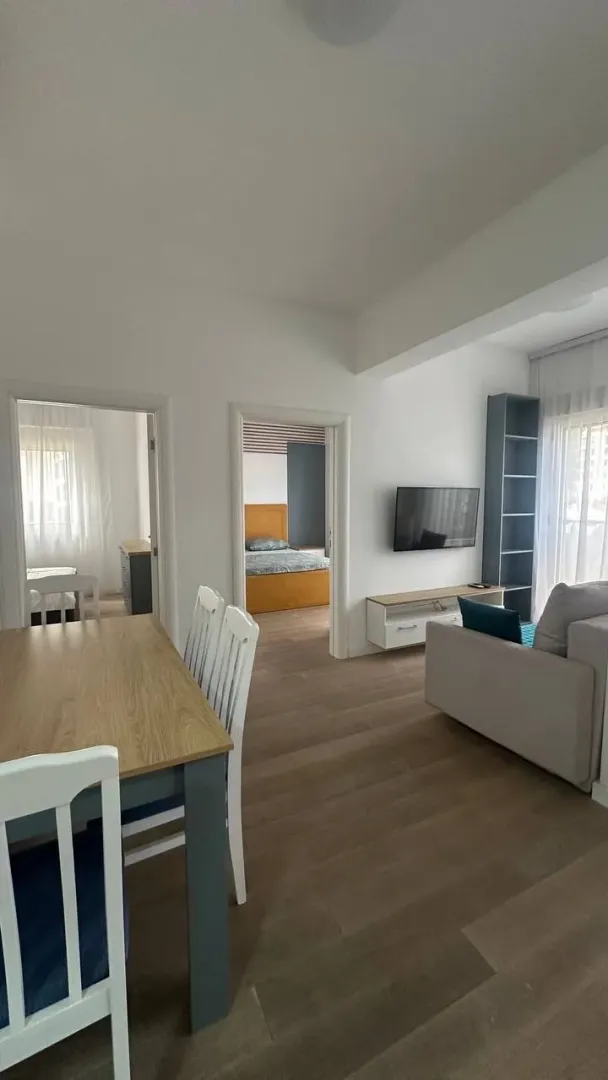 Living room with dining area and a view of the apartment interior.