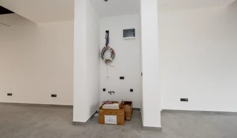 Empty room during construction work with wall installations and boxes on the floor. - image 3