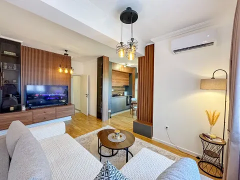 Modern living room with a sofa and a view of the kitchen. - image 2