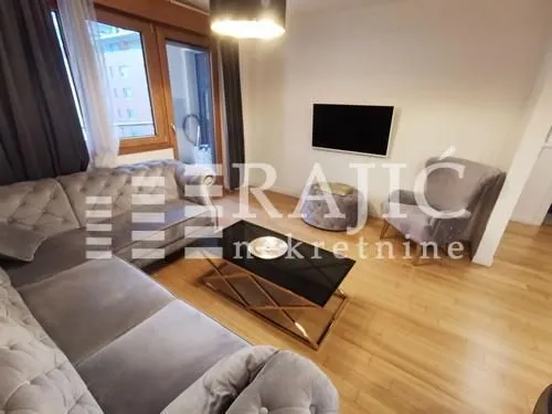 Living room with sofa, armchair and coffee table.