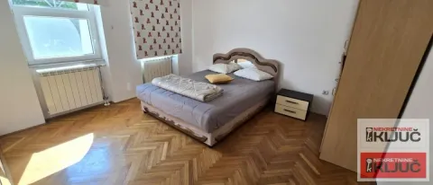 Bedroom with a double bed, parquet flooring, and a wardrobe. - image 25