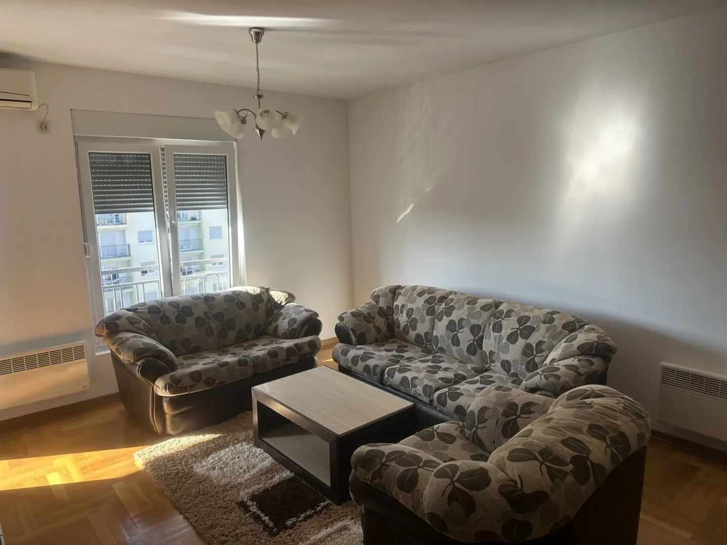 A living room with a sofa set and a coffee table.