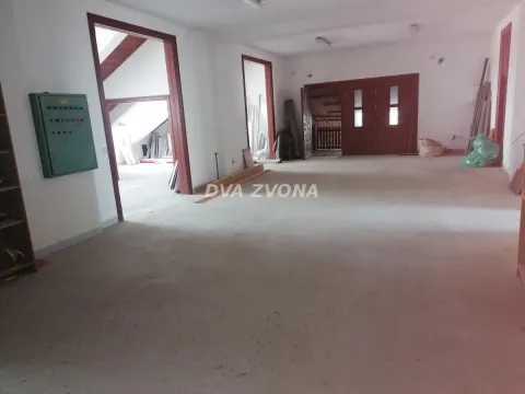 Empty room in a house with a concrete floor and wooden doors. - image 9