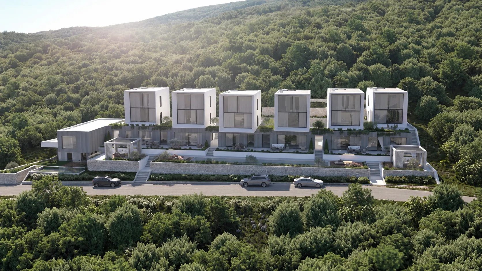 Pogled sa strane na niz modernih vila smještenih u šumovitom okruženju.