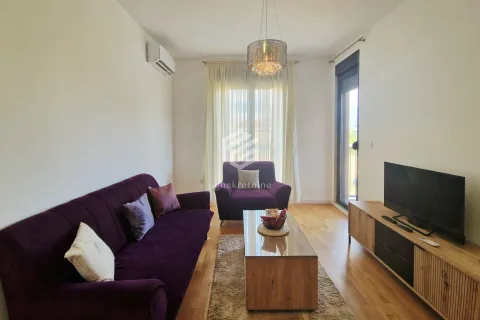 Living room with a purple sofa set, TV cabinet, and access to the terrace. - image 14