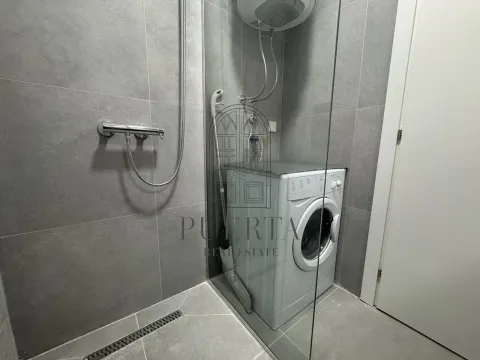 Modernly equipped bathroom with a shower cabin and washing machine. - image 9