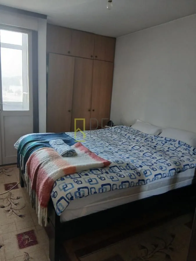Bedroom with a double bed, wardrobe, and terrace access.