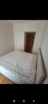 Bedroom with a double bed and built-in wardrobe. - image 11